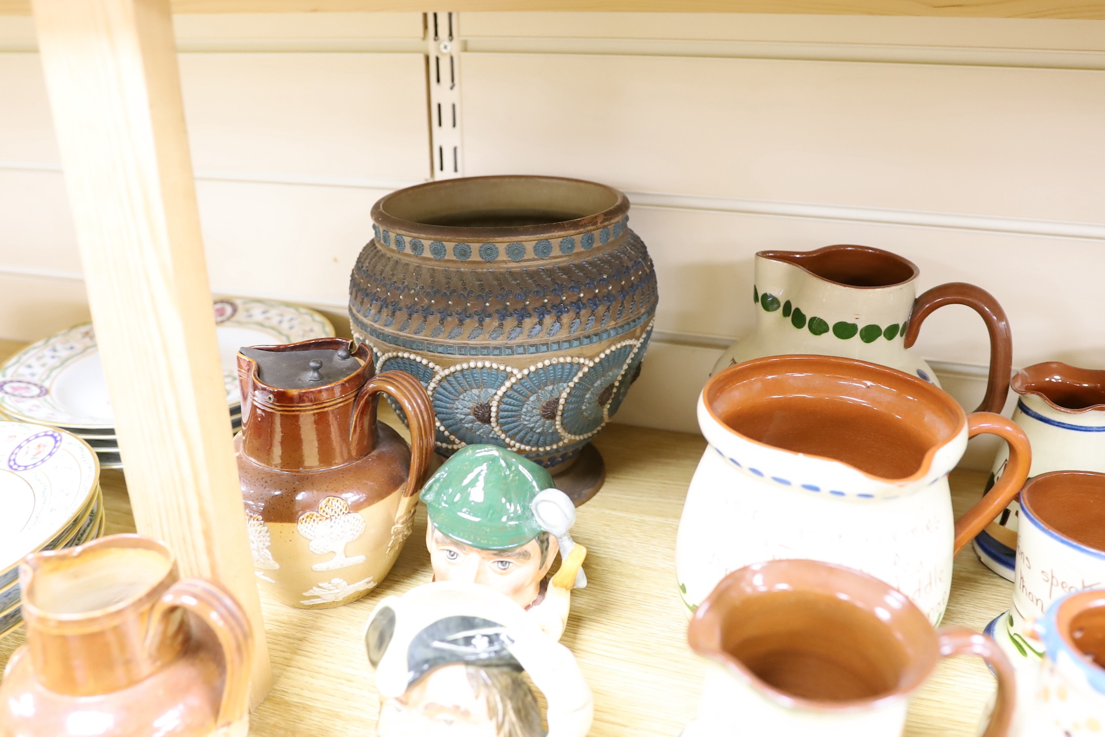 A collection of Doulton vessels and Torquay Mottoware